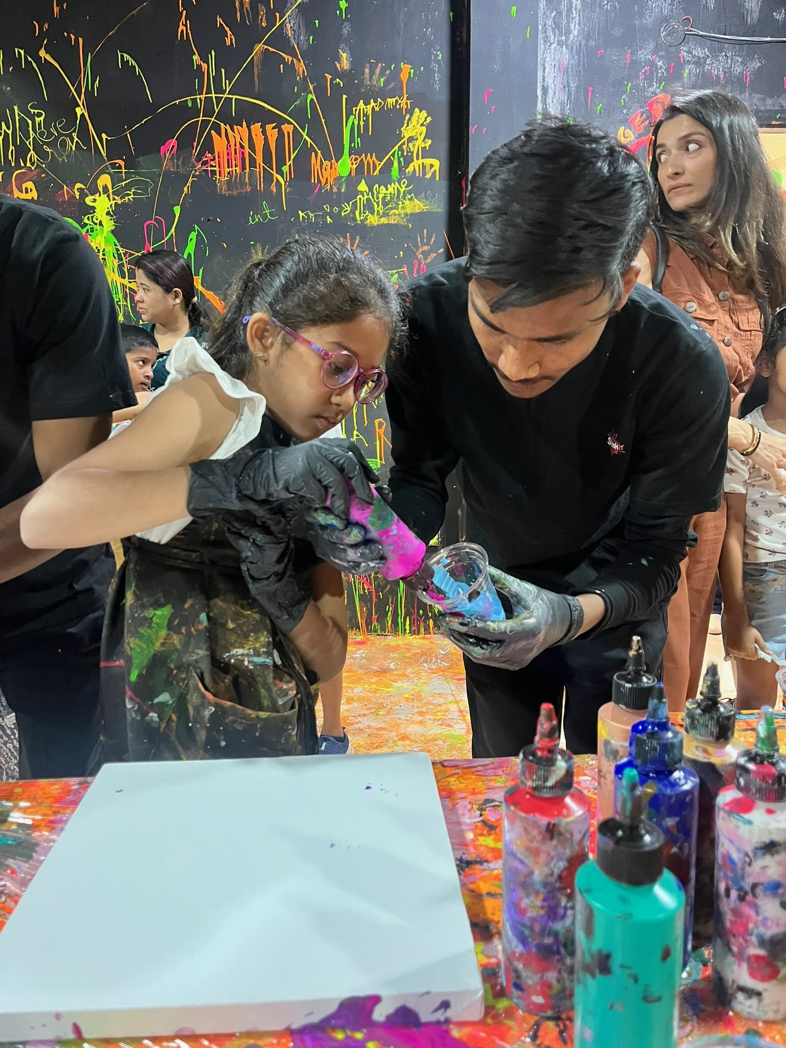 Colourful acrylic swirls forming on a fluid art canvas